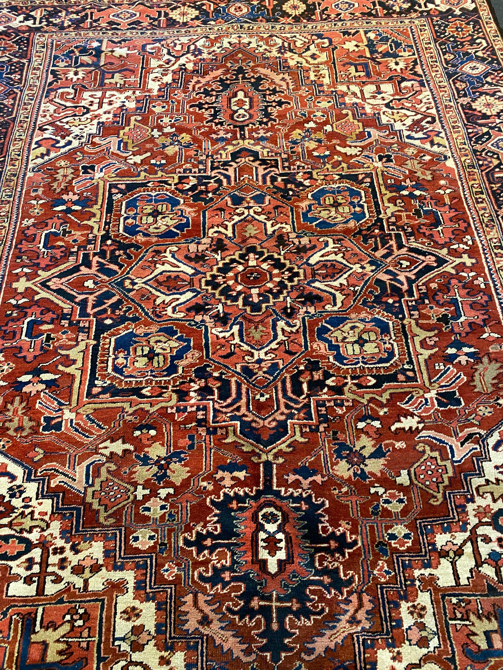 An Heriz red ground carpet, 364 x 265cm